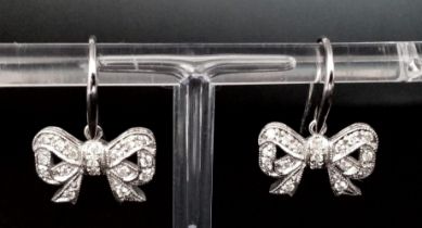 A Pair of 9K White Gold and Diamond Bow Earrings. 3.85g total weight.
