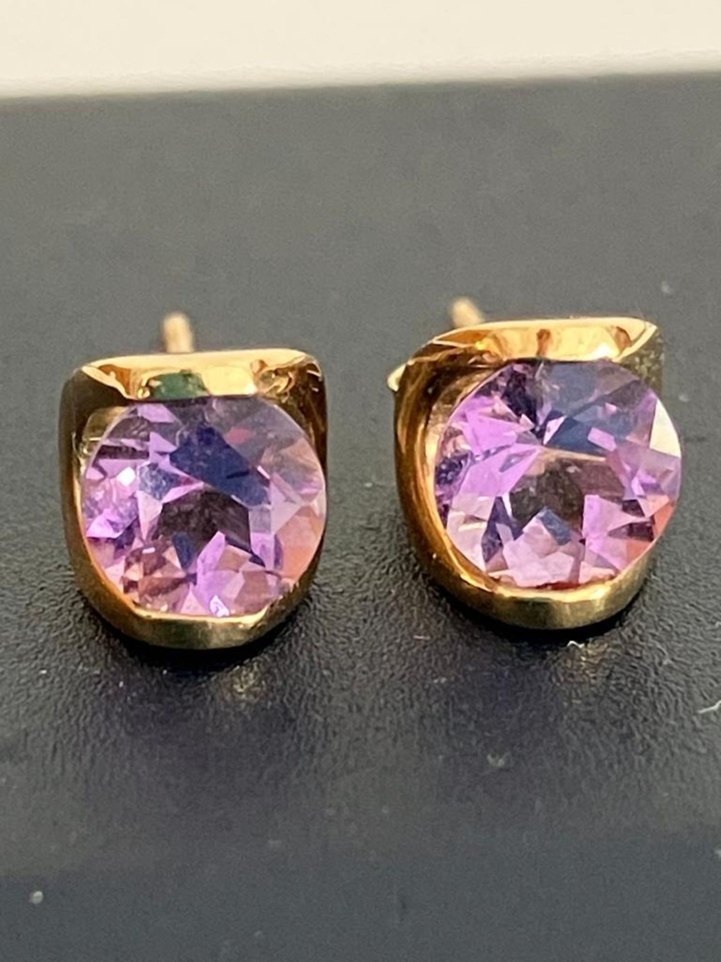 9 carat GOLD EARRINGS set with Round Cut AMETHYST Stones, complete with Gold backs. 0.85 grams.