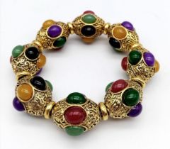 A Gilded Tibetan Style Bracelet with Multi-Colour Jade Cabochon Decoration. Gilded spacers.
