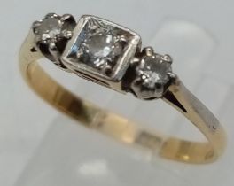 AN 18K YELLOW GOLD DIAMOND 3 STONE RING. Size O, 0.20ctw, 2.7g total weight.