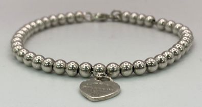 A Tiffany and Co. 925 Silver Ball Link Bracelet with Heart Clasp. 17cm. 5.75g