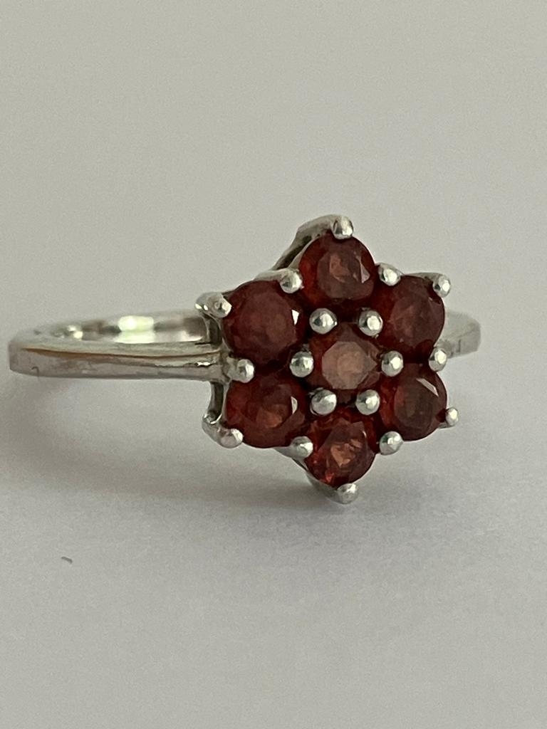 RED TOURMALINE CLUSTER RING Having seven gemstones set in floral/star formation. mounted in 925 - Image 3 of 3