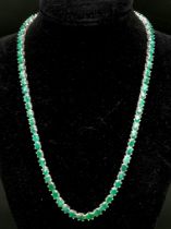 An Emerald Gemstone Tennis Necklace on 925 Silver. Approximately 47cm in length, 34g total weight.