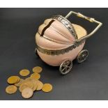 A vintage, baby pram moneybox with over hundred halfpenny coins (various dates) inside. These
