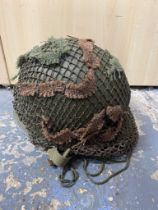 A Late WW2 USA M1c Paratrooper Rear Seam Helmet. Appears to have the number 1160 on the front. The