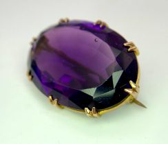 An Antique Amethyst Brooch set in 9K Rose Gold. A large oval well-faceted clean amethyst in a claw