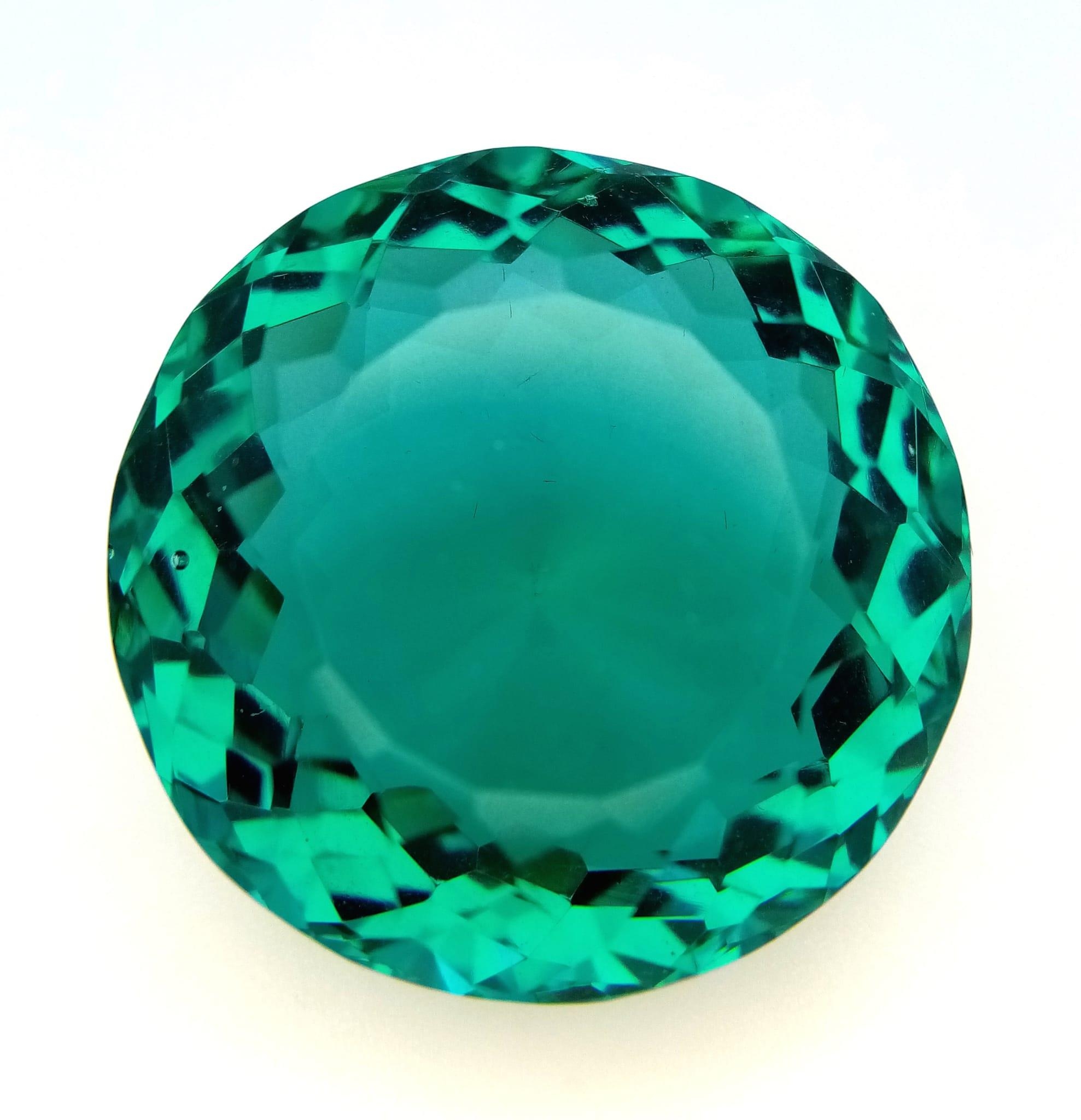 A Bluish Green 71ct Round Cut Grandidierite Gemstone. Round cut with a well faceted trillion base.