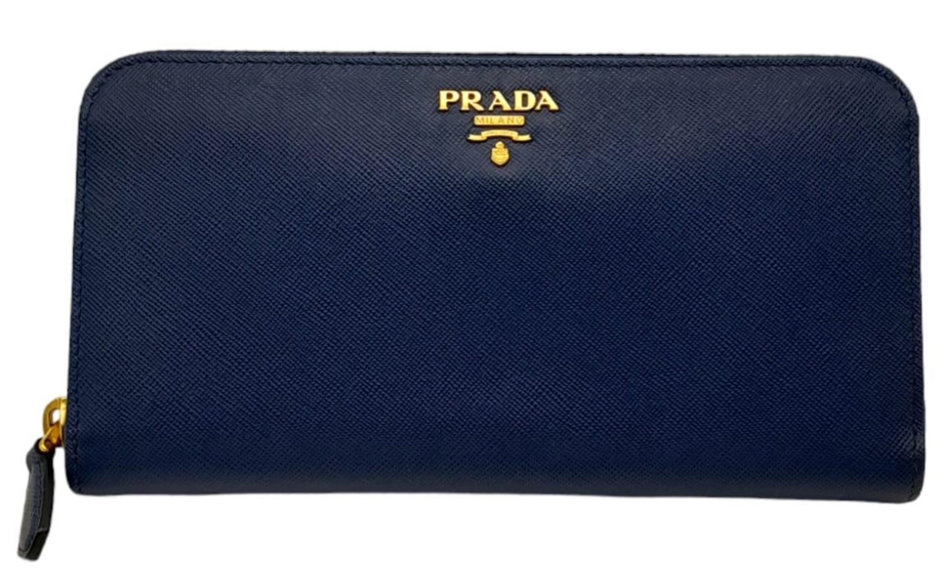 A Prada Royal Blue Purse/Wallet. Saffiano leather exterior, with the Prada logo in gold-toned