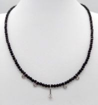 A Black Spinel Small Bead Necklace with Five Stone White Diamond Decoration. 0.5ctw. 14k gold clasp.