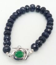 A 140ct Blue Sapphire Rondelle Bracelet with Emerald and 925 Silver Clasp. 17cm.