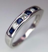 18k white gold diamond and sapphire half eternity ring. Weight: 3.5g Size N (dia: 0.20ct/ sapp: 0.