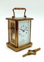 A Vintage Matthew Norman Gilded Carriage Clock. In very good condition and working order. 11cm tall.