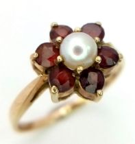 9k yellow gold garnet and pearl floral cluster ring. Weight: 2.3g Size N (0.78ct/pearl:5mm)