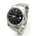 A Rolex Oyster Perpetual Date Midsize Watch. Stainless steel bracelet and case - 35mm. Black dial