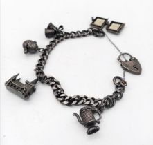 A Vintage 925 Silver Charm Bracelet with Heart Clasp. 44.53g total weight.