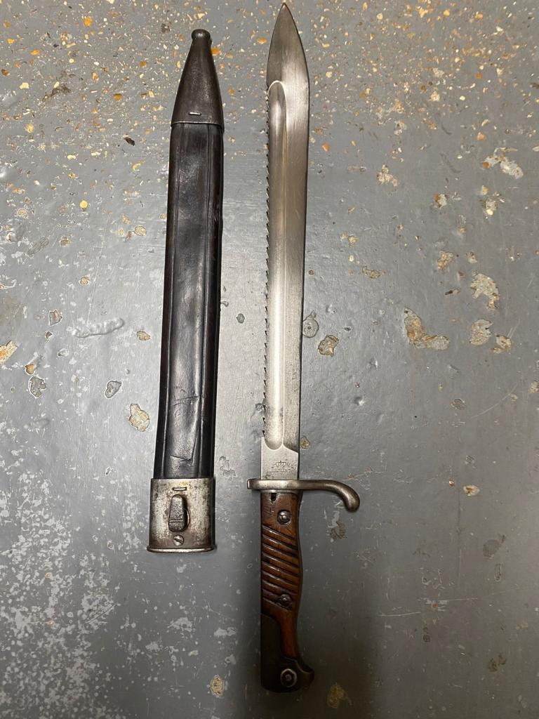 A WW1 German Saw-Back Bayonet - Makers mark of Erfurt. Comes with scabbard. ML347