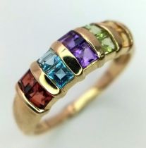 A 9K YELLOW GOLD GEM SET RING. Includes peridot, garnet, topaz, amethyst and citrine. Size P, 2.4g