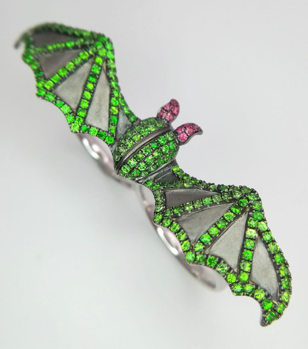 An 18K White Gold Bat Ring! An Emerald and Ruby bat flies over two gold expandable rings. Size P - - Image 3 of 6