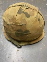 An Interesting USA WW2 Rear Seam Helmet with a WW2 Cover and a Vietnam War Era Liner. The cover is