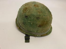 A USA M1 Helmet - The cover is marked but it is difficult to make the date out. The liner is dated