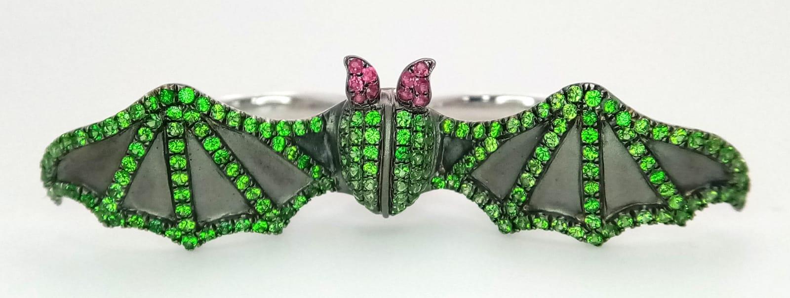 An 18K White Gold Bat Ring! An Emerald and Ruby bat flies over two gold expandable rings. Size P - - Image 2 of 6