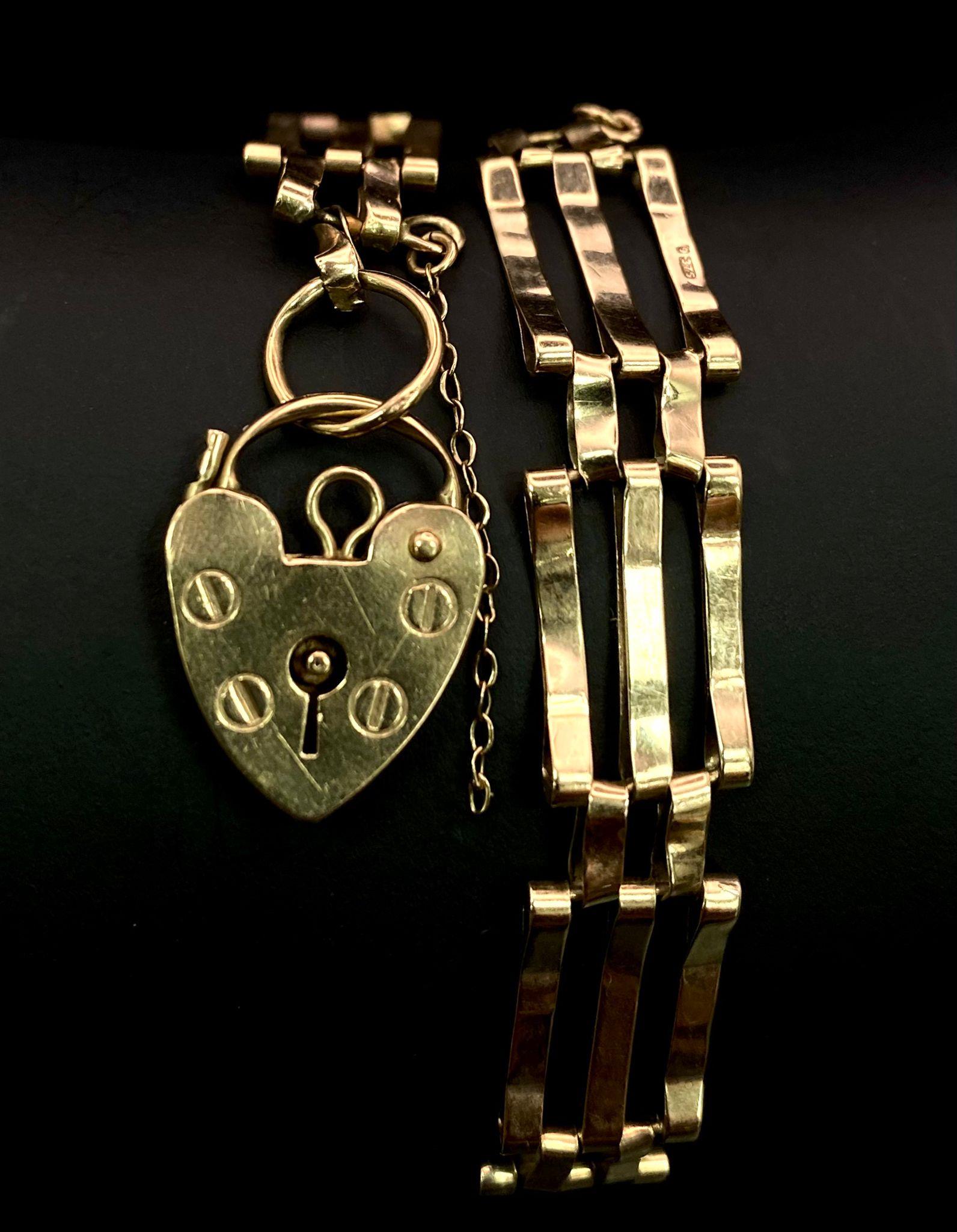 A VINTAGE 9K GOLD 3 ROW GATE BRACELET WITH HEART PADLOCK . 6.9gms