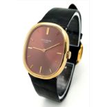 A Vintage Patek Phillipe 18K Gold Gents Watch. Original black leather strap with 18k gold buckle.