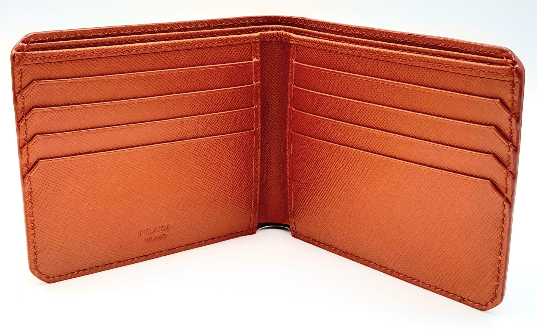 A Prada Burnt Orange Wallet. Leather exterior and interior, with silver-toned logo hardware. Two - Image 4 of 6