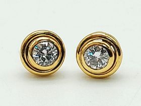 A Pair of 18K Gold Diamond Stud Earrings. 0.40ctw bright round cut diamonds. No butterflies. 1.86g