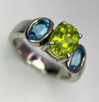 Sterling Silver Three Gemstone Ring. Two gleaming blue stones off each shoulder with a stunning