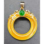 A Yellow Jade Circle Pendant. 3cm diameter. Gilded attachments.