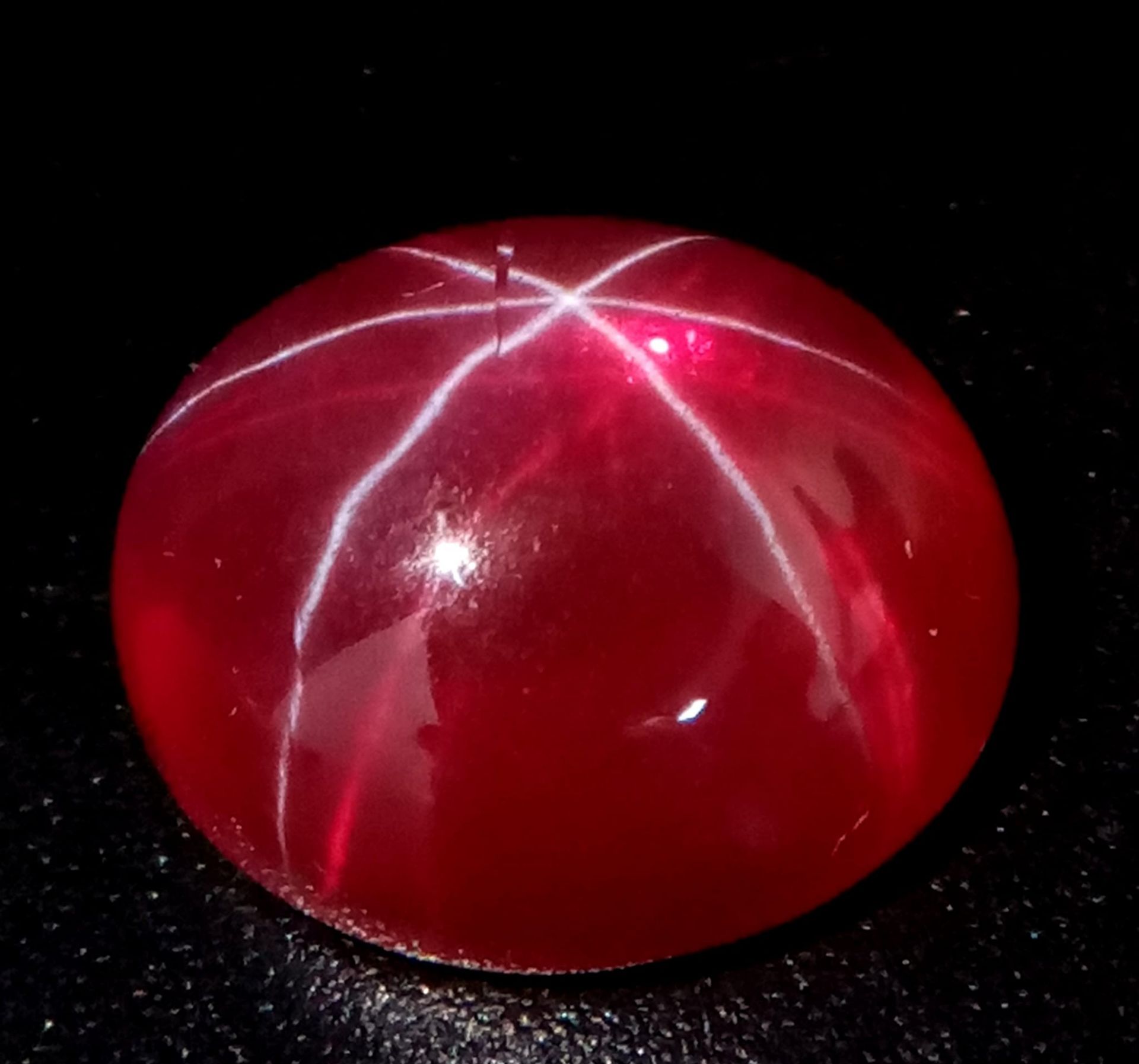 A spectacular wonder of nature, a sizeable (13.5 carats), STAR RUBY of oval cabochon shape. Strong