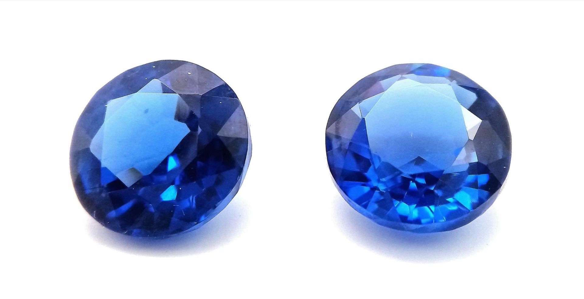 An excellent pair of round cut, dark blue SAPPHIRES. Approximately 10 carats each, with no cracks,