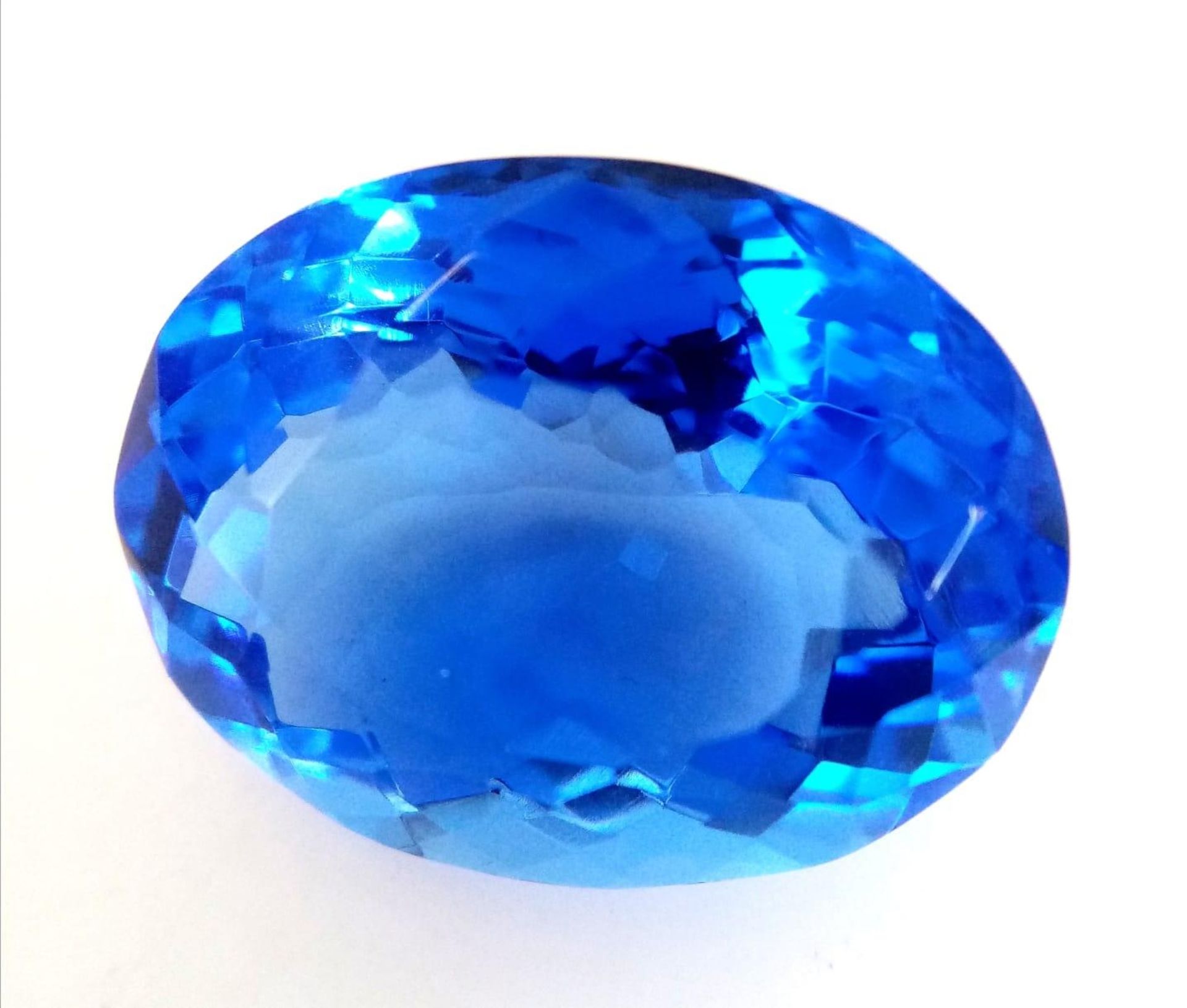 A fabulous, large (51.2 carats) Blue TOPAZ. Oval cut with excellent colour saturation and