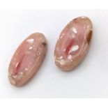 A very unusual pair of PINK OPAL oval cabochons with organic fossil remains of molluscs. Dimensions: