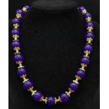 An Amethyst Bead Necklace with Gilded Spacers and Clasp. 44cm length. 12mm beads.