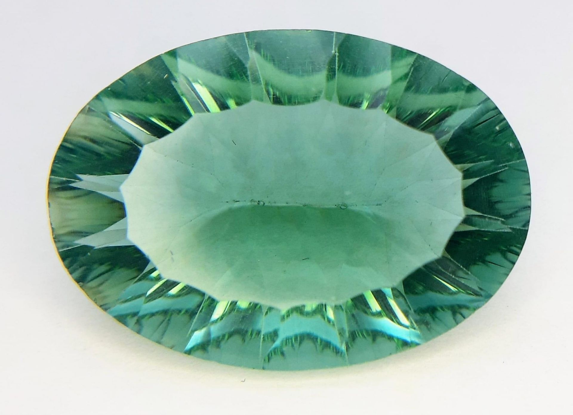 An amazing, rare light green, large (23.0 carats) TOPAZ. Customised oval cut, in excellent condition