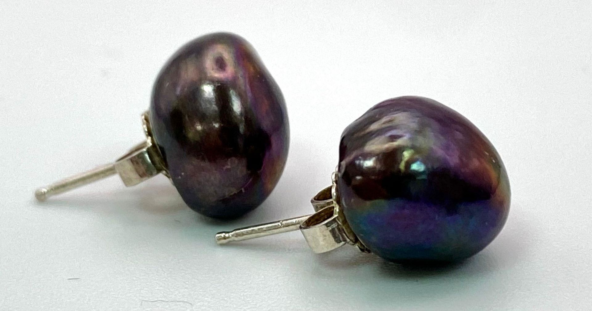 A Pair of Cultured Black Pearl Stud Earrings.