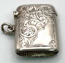 An Antique Sterling Silver Vesta Case. Engraved scroll decoration. Working hinge. Hallmarks for