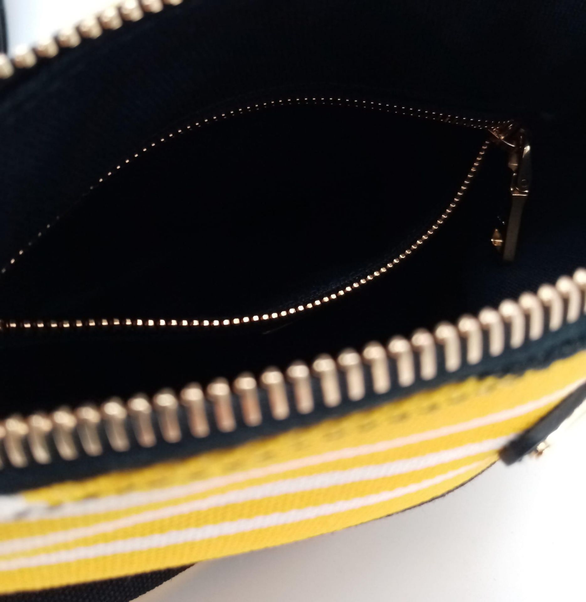 A Prada Yellow, Black and White Pouch. Textile exterior, with gold tone hardware and top zip, and - Image 9 of 13