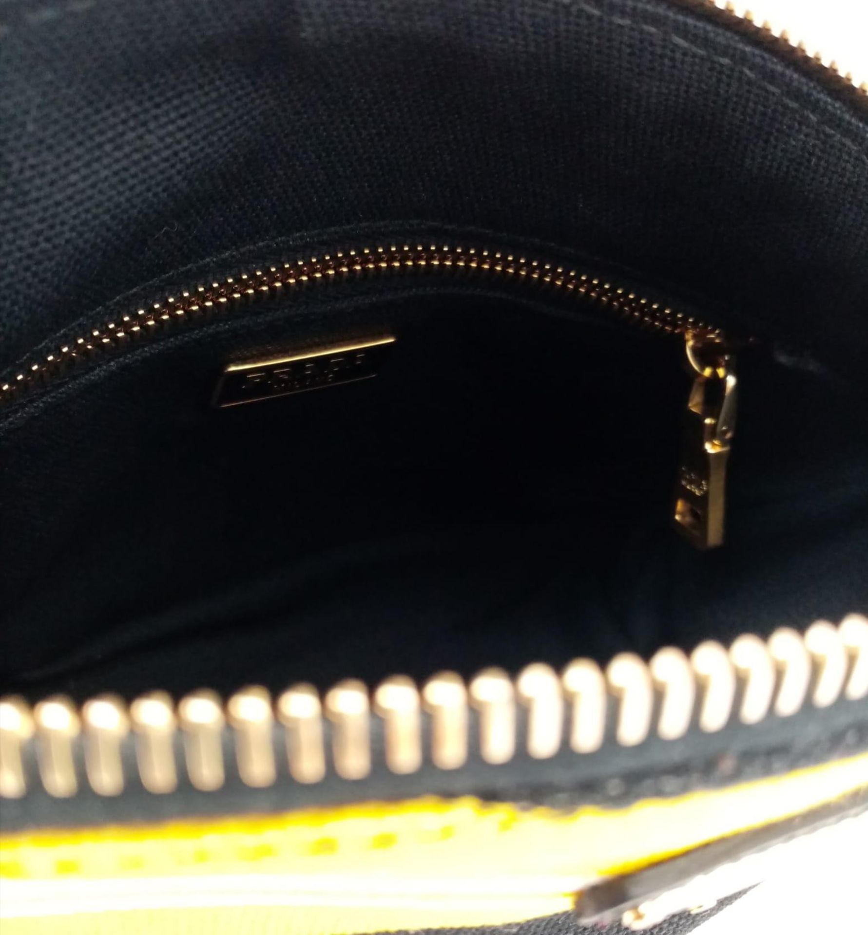 A Prada Yellow, Black and White Pouch. Textile exterior, with gold tone hardware and top zip, and - Image 6 of 13