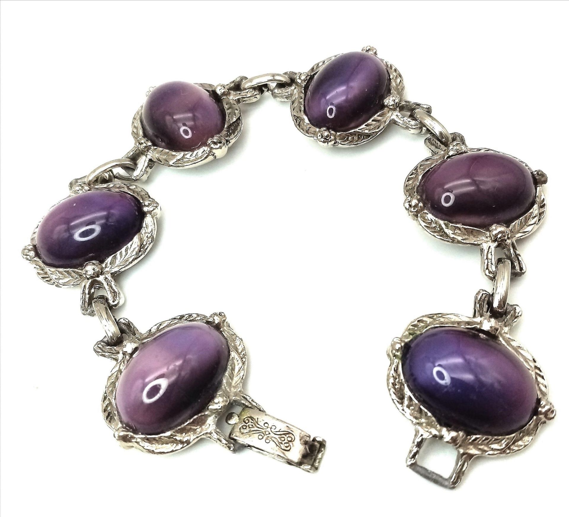 A wonderful example of a vintage, mesmerising, purple cat’s eyes bracelet, in a presentation case: