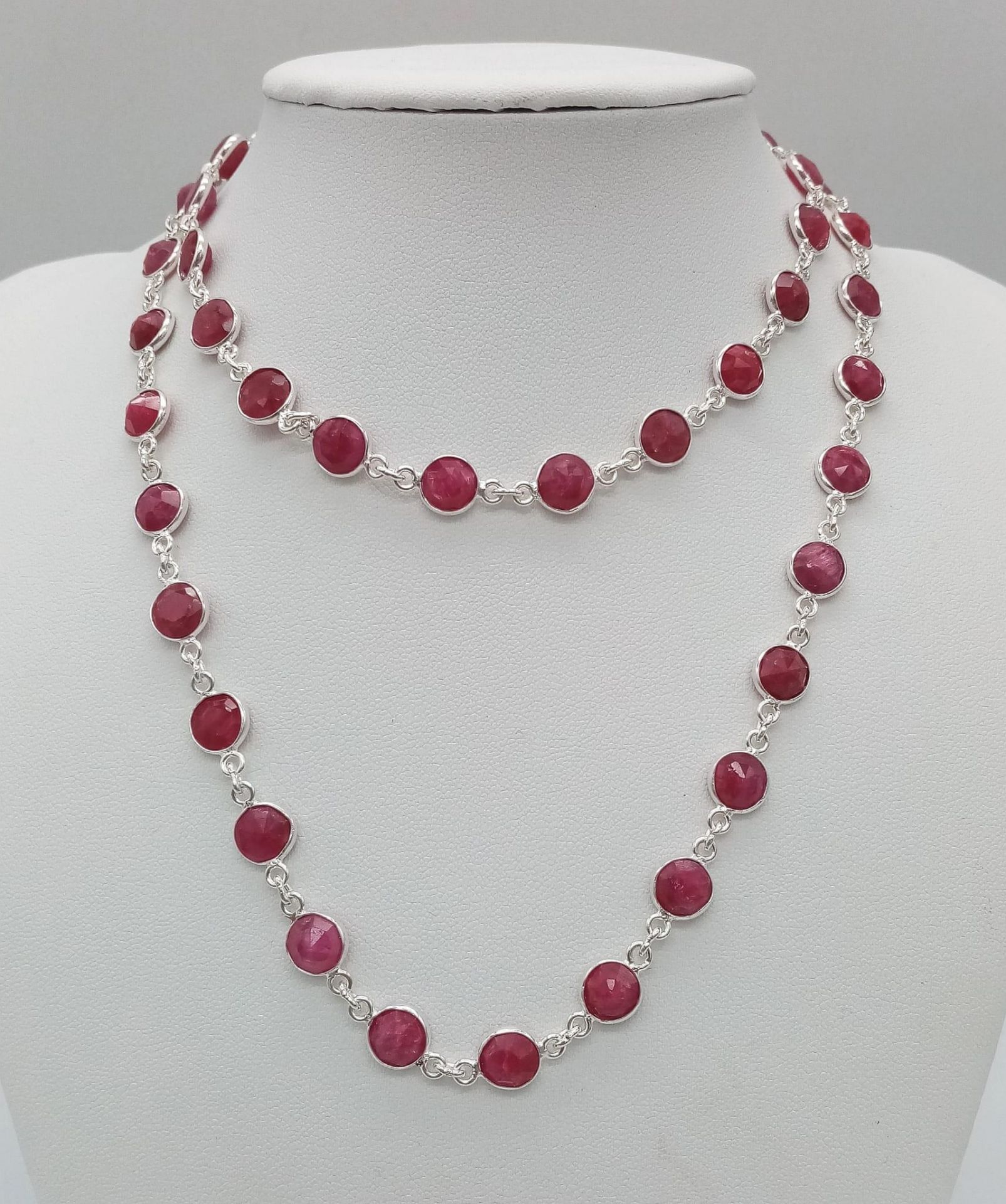 A Round Cut Ruby Gemstone Tennis Necklace set in 925 Silver. 70cm. 27.75g total weight.