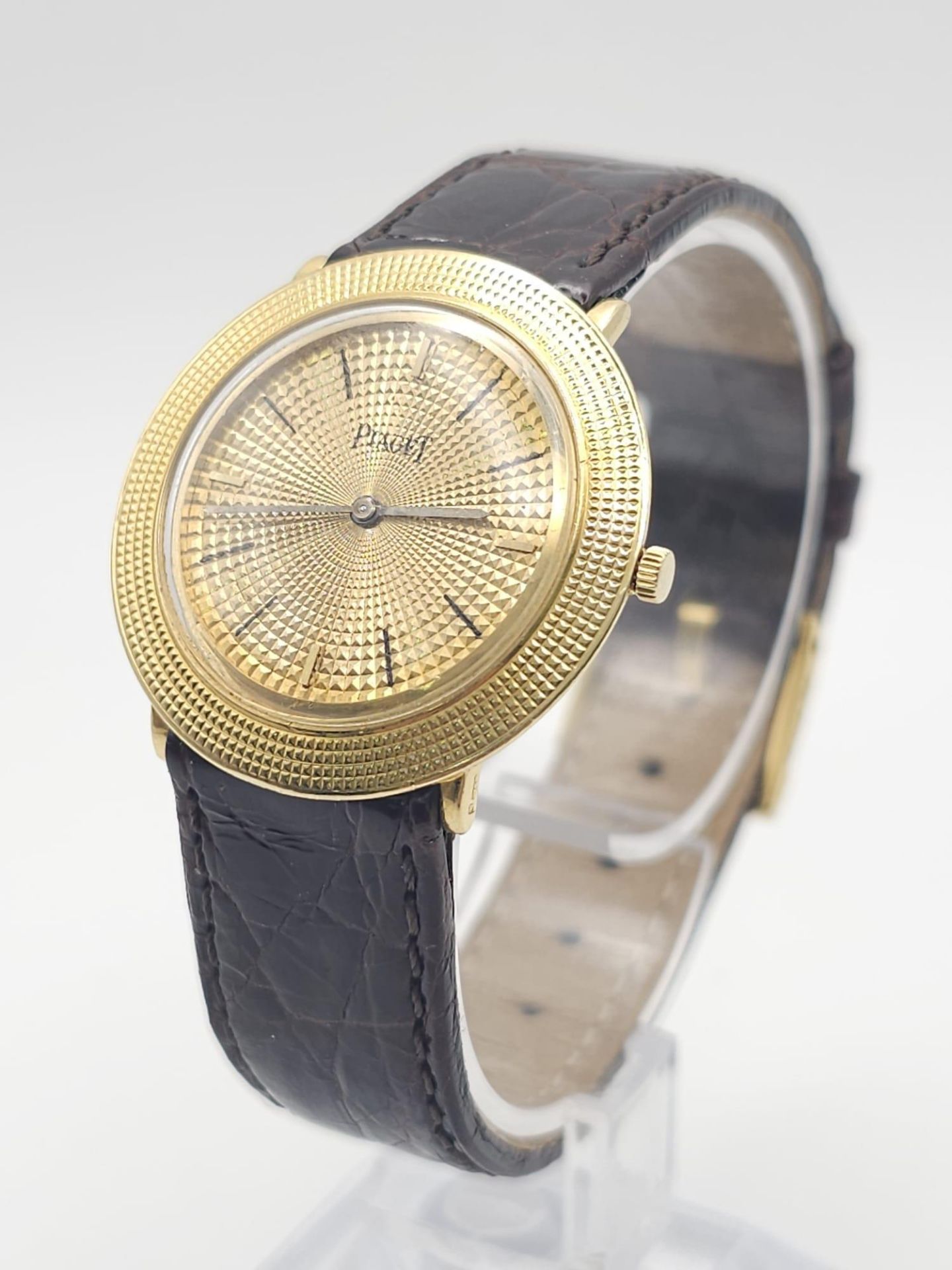 A Vintage 18K Gold Piaget Gents Watch with Hypnotic Dial. Brown crocodile strap. 18k gold case -