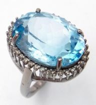 An Ice Blue Topaz and 925 Silver Ring with a Rose-Cut Diamond Halo. Blue topaz-16.50ct. Diamonds-0.