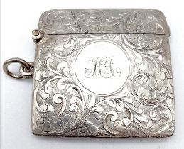 An Antique Sterling Silver Vesta Case. Scrolled engraving with monogram cartouche. Hinge in
