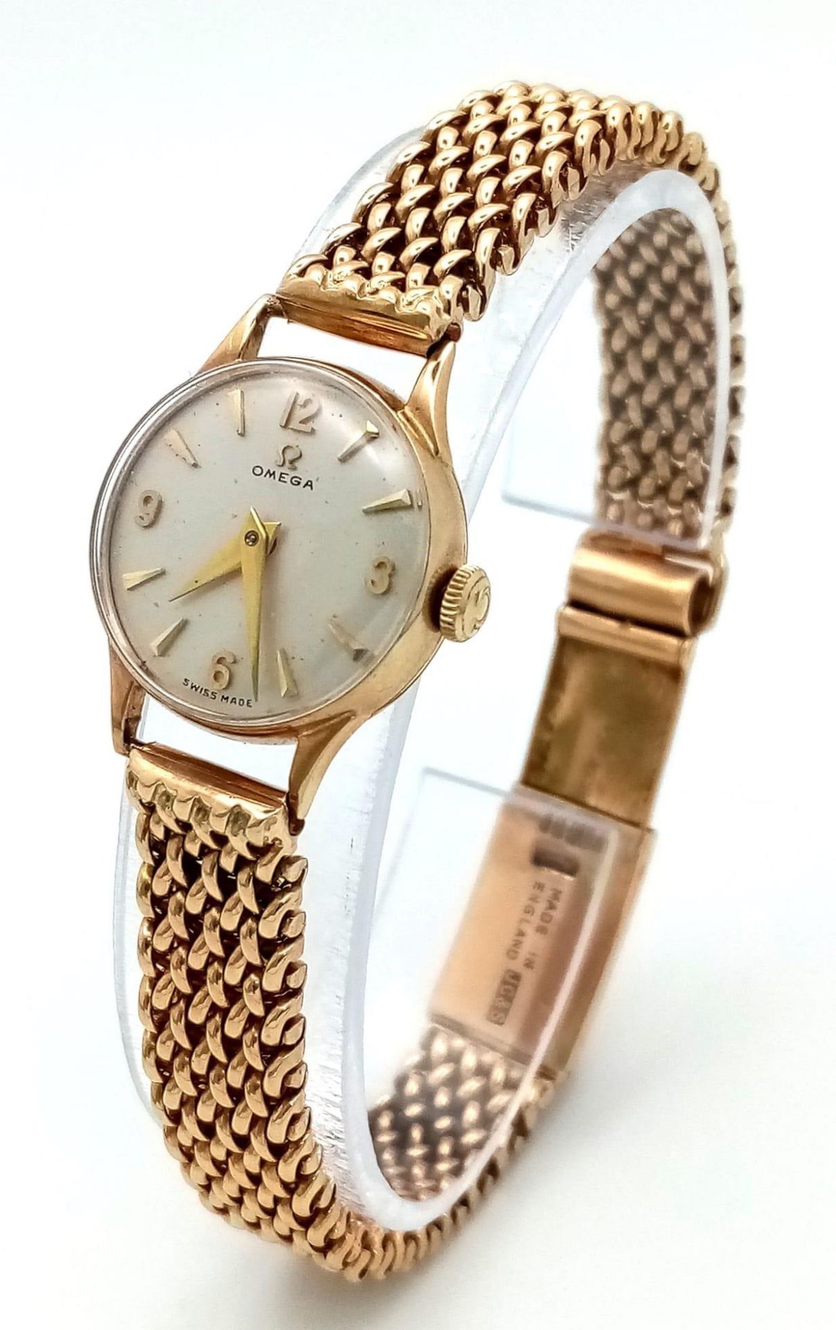 A Vintage 9K Yellow Gold Omega Watch. 9k gold mesh bracelet. 9k gold case - 19mm. White dial.