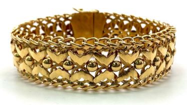 A 9K GOLD INTERLINK BRACELET ORNATE X-FACTOR DESIGN ALSO HAVING A SAFETY CATCH AND SAFETY CHAIN .