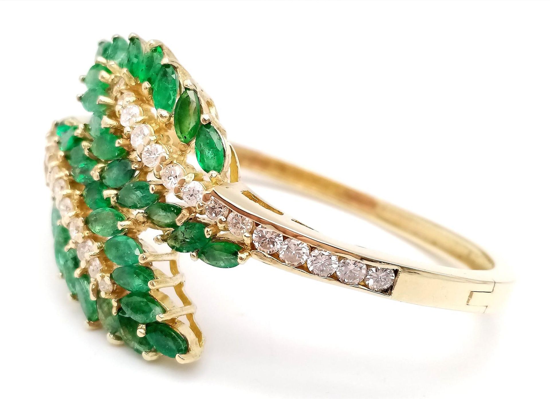 A DIAMOND AND EMERALD LEAF DESIGN BANGLE IN CROSSOVER STYLE SET IN18K GOLD . 33.5gms 10457 - Image 5 of 15