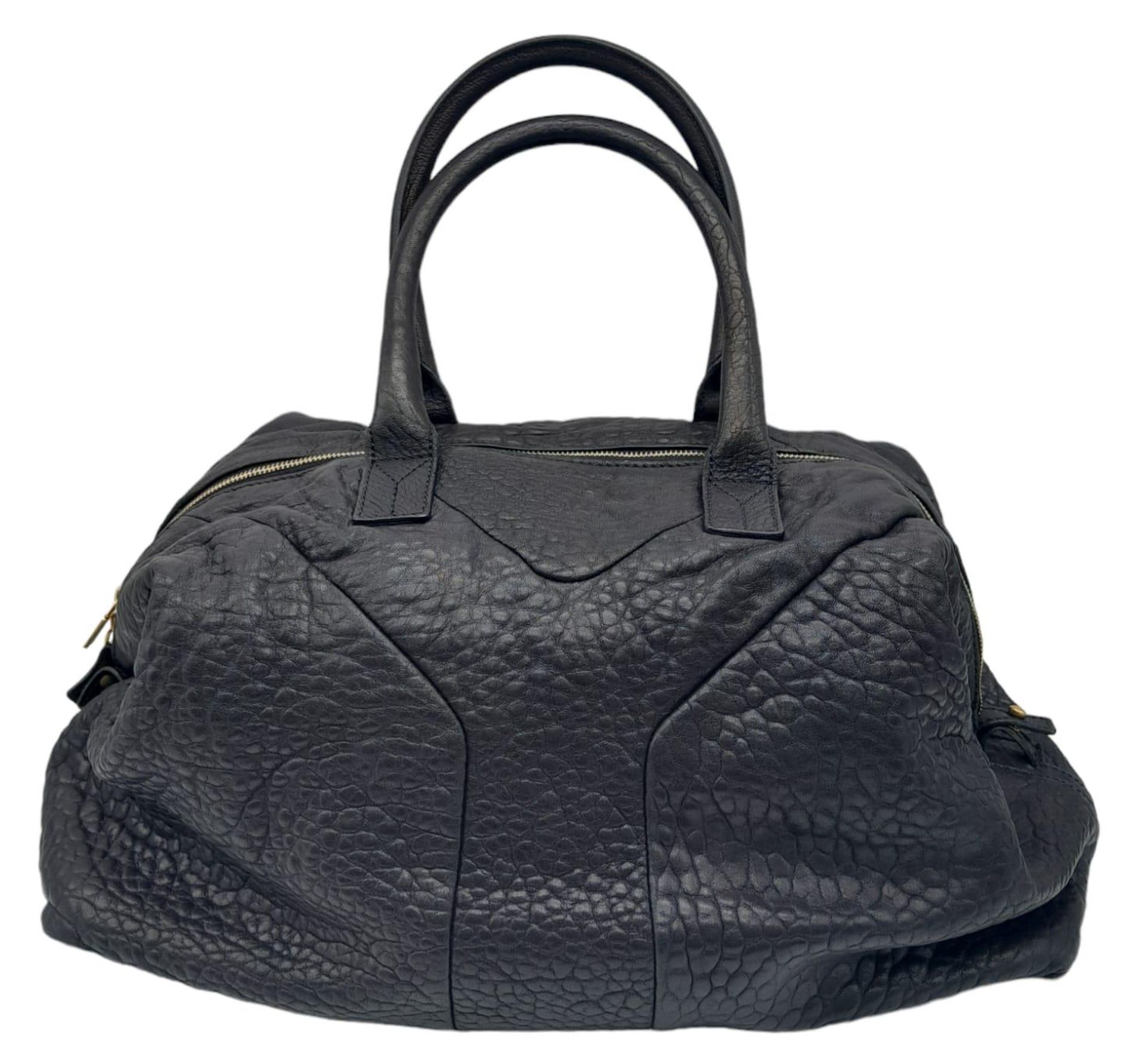 An Yves Saint Laurent Black Easy Bag. Leather exterior with gold hardware, double zipper, and 5